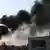 A grab from a handout video made available by Shaam News network on Sept. 1, 2012, shows a building on fire after a shelling in the city of Aleppo