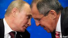 Russian President Vladimir Putin, left, talks with his Foreign Minister Sergei Lavrov as they wait for a bilateral meeting with Japanese Prime Minister Yoshihiko Noda at the APEC summit in Vladivostok, Russia, Saturday, Sept. 8, 2012. (AP Photo/G/Sergei Karpukhin,Pool)