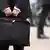 business man holding a briefcase in a fast moving corporate environment 56533 Andres Rodriguez - Fotolia 2005