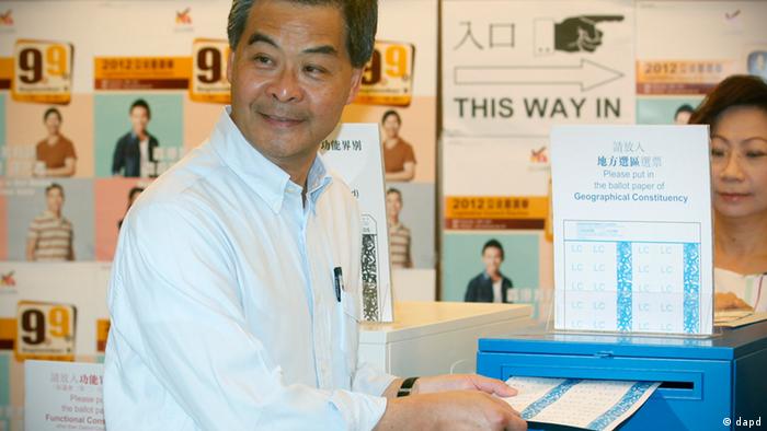 Hong Kong Chief Executive Leung Chun-ying, left and his wife Regina vote at a polling station for the legislative council election in Hong Kong, Sunday, Sept. 9, 2012. Hong Kong voters cast their ballots Sunday in legislative council elections that will see them choosing more than half the seats for the first time. Voters are selecting 40 representatives while 30 others are chosen by business and special interest groups. In previous votes, it was evenly split but 10 new seats have been added this time. (AP Photo/Kin Cheung)