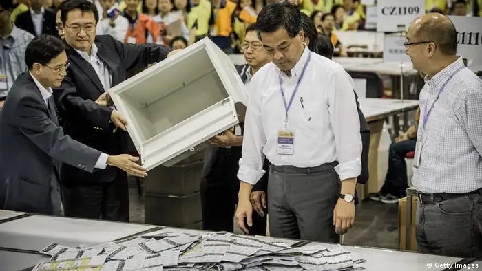 Hong Kong Chief Executive Leung Chun-ying (C) opens a ballot box at a ballot counting centre in Hong Kong on early September 10, 2012. Hong Kong voters went to the polls on September 9 in legislative elections seen as a crucial test for the Beijing-backed government, as calls for full democracy grow and disenchantment with Chinese rule surges. AFP PHOTO / Philippe Lopez (Photo credit should read PHILIPPE LOPEZ/AFP/GettyImages)