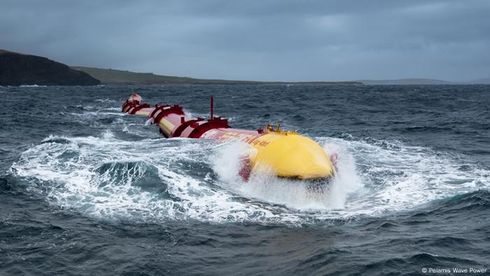 The vast, worm-like Pelamis Wave Power energy converter at sea and riding the waves.