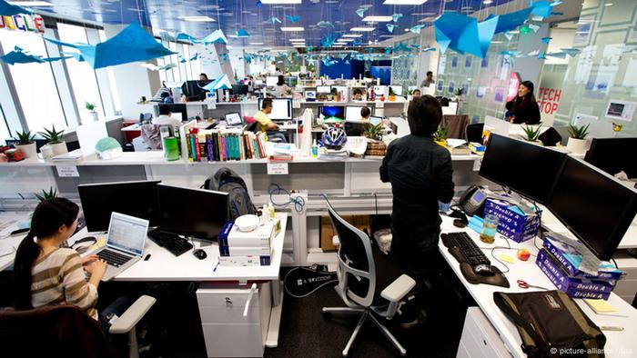 Staff members are seen working at the office of Google at the International Finance Center in Shanghai, China, 25 April 2012.