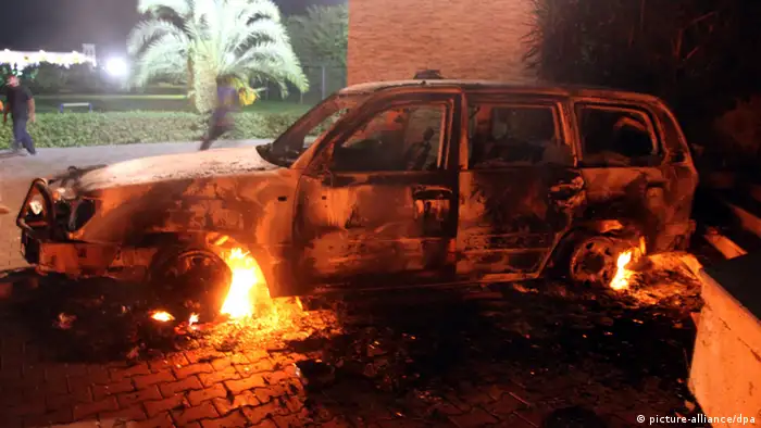 epa03395552 A photo made available on 12 September 2012, shows a vehicle set on fire at the US consulate, in Benghazi, Libya, 11 September 2012. Media reports state that the US ambassador to Libya, Chris Stevens, and three others were killed on 11 September when armed men stormed the US consulate in Benghazi during a protest over a film they said offended Islam. EPA/MUSTAFA EL-SHRIDI
