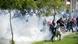 Protesters run for cover during a demonstration in front of the U.S. Embassy in Tunis September 14, 2012. At least five protesters were wounded when Tunisian police opened fire on Friday to quell an assault on the U.S. embassy compound in the capital Tunis, a Reuters reporter said. It was not immediately clear if police fired live rounds or rubber bullets. A large fire erupted inside the compound which has been invaded by hundreds of people incensed by a U.S.-made film that demeans the Prophet Mohammad. REUTERS/Zoubeir Souissi (TUNISIA - Tags: POLITICS CIVIL UNREST RELIGION) Protesters run for cover during a demonstration in front of the U.S. Embassy in Tunis September 14, 2012. At least five protesters were wounded when Tunisian police opened fire on Friday to quell an assault on the U.S. embassy compound in the capital Tunis, a Reuters reporter said. It was not immediately clear if police fired live rounds or rubber bullets. A large fire erupted inside the compound which has been invaded by hundreds of people incensed by a U.S.-made film that demeans the Prophet Mohammad. REUTERS/Zoubeir Souissi (TUNISIA - Tags: POLITICS CIVIL UNREST RELIGION)