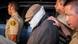 REFILE - UPDATING CAPTION WITH IDENTITY OF PERSON BEING ESCORTED Nakoula Basseley Nakoula (C) is escorted out of his home by Los Angeles County Sheriff's officers in Cerritos, California September 15, 2012. Nakoula, a California man convicted of bank fraud has been escorted to an interview with federal officers probing possible probation violations stemming from the making of an anti-Islam video that has triggered violent protests in the Muslim world, police said on Saturday. A Los Angeles County Sheriff's spokesman said Nakoula voluntarily left his home, accompanied by sheriff's deputies, to meet with the officers in the Cerritos Sheriff's Station. The obscure 13-minute English-language video, which was filmed in California and circulated on the Internet under several titles including "Innocence of Muslims," portrays Prophet Mohammad engaged in crude and offensive behavior. REUTERS/Bret Hartman (UNITED STATES - Tags: RELIGION CRIME LAW POLITICS TPX IMAGES OF THE DAY) REFILE - UPDATING CAPTION WITH IDENTITY OF PERSON BEING ESCORTED Nakoula Basseley Nakoula (C) is escorted out of his home by Los Angeles County Sheriff's officers in Cerritos, California September 15, 2012. Nakoula, a California man convicted of bank fraud has been escorted to an interview with federal officers probing possible probation violations stemming from the making of an anti-Islam video that has triggered violent protests in the Muslim world, police said on Saturday. A Los Angeles County Sheriff's spokesman said Nakoula voluntarily left his home, accompanied by sheriff's deputies, to meet with the officers in the Cerritos Sheriff's Station. The obscure 13-minute English-language video, which was filmed in California and circulated on the Internet under several titles including "Innocence of Muslims," portrays Prophet Mohammad engaged in crude and offensive behavior. REUTERS/Bret Hartman (UNITED STATES - Tags: RELIGION CRIME LAW POLITICS TPX IMAGES OF THE DAY)