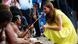 Catherine, the Duchess of Cambridge, (R) talks to a woman in traditional costume Catherine, the Duchess of Cambridge, (R) talks to a woman in traditional costume