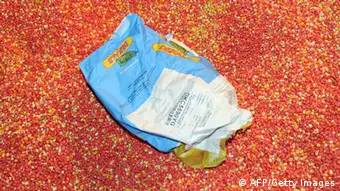 A bag containing 'MON 810', a variety of genetically modified maize (corn) developed by Monsanto Company has been ripped opened by anti-GMO activists on January 23, 2012 at a Monsanto storehouse in Trebes near Carcassonne, southern France, during an action to call for the ban of this product. AFP PHOTO / ERIC CABANIS (Photo credit should read ERIC CABANIS/AFP/Getty Images)