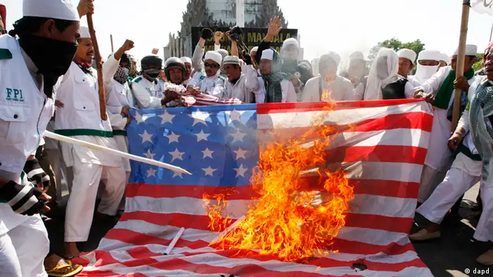 Muslim protesters burn an American flag during a protest against an anti-Islam film produced in the United States in Makassar, South Sulawesi province, Indonesia, Friday, Sept, 21, 2012. The U.S. has closed its diplomatic missions across Indonesia due to continuing demonstrations over the film Innocence of Muslims, which denigrates the Prophet Muhammad. (AP Photo/Abbas Sandji)