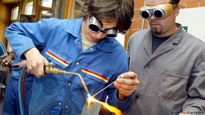 Trainee welding in a German metal industry program Copyright: dpa