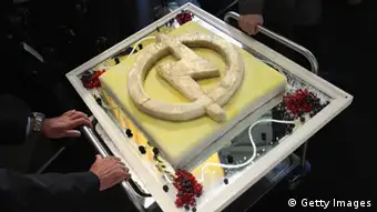 RUESSELSHEIM, GERMANY - SEPTEMBER 22: Employees wheel in a cake decorated with the Opel logo at the Opel Insignia and Astra factory during a celebration marking Opel's 150th anniversary on September 22, 2012 in Ruesselsheim, Germany. The troubled carmaker, which has been owned by General Motors (GM) since the 1920s, is struggling to return to profits and reassert its brand imagery. (Photo by Sean Gallup/Getty Images)