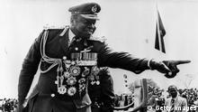 Idi Amin (1925 - ) President of Uganda, with all his medals, points a finger during an outdoor rally. (Photo by Keystone/Getty Images)