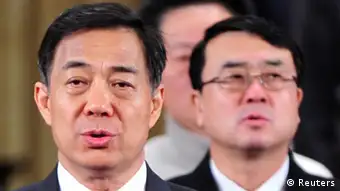 China's former Chongqing Municipality Communist Party Secretary Bo Xilai (L) and former Deputy Mayor of Chongqing Wang Lijun (R) sing the national anthem during a session of the Chinese People's Political Consultative Conference (CPPCC) of the Chongqing Municipal Committee, in Chongqing municipality in this January 7, 2012 file photo. Wang, the former police chief at the heart of China's biggest political scandal in decades faces trial next week on charges of defection, taking bribes and illegal surveillance. REUTERS/Stringer/Files (CHINA - Tags: CRIME LAW POLITICS) CHINA OUT. NO COMMERCIAL OR EDITORIAL SALES IN CHINA