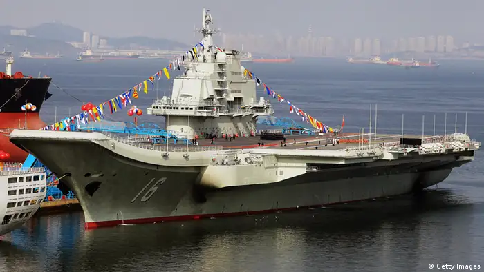 This photo taken on September 24, 2012 shows China's first aircraft carrier, a former Soviet carrier called the Varyag, docked after its handover to the People's Liberation Army (PLA) navy in Dalian, northeast China's Liaoning province. China's first aircraft carrier was handed over on September 23 to the navy of the People's Liberation Army, state press said, amid rising tensions over disputed waters in the East and South China Seas. CHINA OUT AFP PHOTO (Photo credit should read STR/AFP/GettyImages)