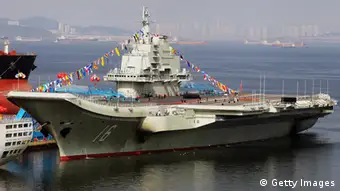 This photo taken on September 24, 2012 shows China's first aircraft carrier, a former Soviet carrier called the Varyag, docked after its handover to the People's Liberation Army (PLA) navy in Dalian, northeast China's Liaoning province. China's first aircraft carrier was handed over on September 23 to the navy of the People's Liberation Army, state press said, amid rising tensions over disputed waters in the East and South China Seas. CHINA OUT AFP PHOTO (Photo credit should read STR/AFP/GettyImages)