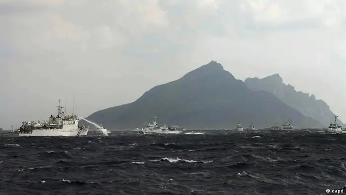 In this photo released by Taiwan's Central News Agency, a Taiwan Coast Guard patrol boat, left, sprays its water cannon towards a Japan Coast Guard patrol boat off the disputed islands called Senkaku in Japan and Diaoyu in China, in the East China Sea, Tuesday, Sept. 25, 2012. On Tuesday morning, about 50 Taiwanese fishing boats accompanied by 10 Taiwanese surveillance ships came within almost 20 kilometers (about 12 miles) of the disputed islands- within what Japan considers to be its territorial waters. (AP Photo/Central News Agency) TAIWAN OUT