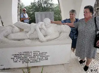 ** FILE ** Lilia Pardini, right, and her sister Licia touch a sculpture depicting their mother and sister who were killed along with more than 500 others in 1944 by Nazi SS troops, at the 60th anniversary commemoration ceremony of the slaughter in Sant'Anna di Stazzema, Italy, in this Thursday, Aug. 12, 2004 file photo. Italian judges Wednesday, June 22, 2005 convicted 10 former members of the Nazi SS accused of taking part in the massacre, and sentenced them in absentia to life in prison, a defense lawyer said. (AP Photo/Fabio Muzzi)