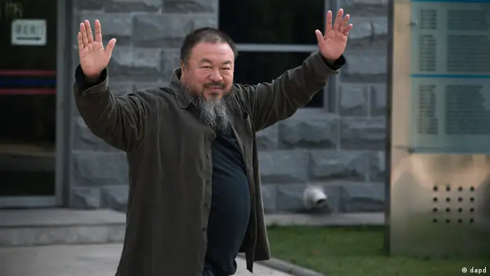 Chinese Activist artist Ai Weiwei waves to the journalists as he arrives to the Beijing No. 2 People's Intermediate Court in Beijing Thursday, Sept. 27, 2012. Chinese authorities on Thursday rejected Ai’s second appeal of a $2.4 million tax fine, meaning his design company will have to pay the penalty. (AP Photo/Andy Wong)