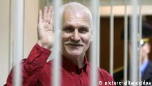 epa03013553 A Belarussian human rights activist Ales Bialiatski (also transliterated as Alex Belyatsky) waves from a cage in a court room during a court session in Minsk, Belarus, 24 November 2011. Ales Bialiatski is a leader of Viasna, a human rights group based in Minsk. He was arrested on 04 August 2011 and charged with tax evasion, after Polish and Lithuanian prosecutors gave Belorussian police information about Vesna's bank accounts in their countries. The court in Minsk on 24 November convicted him and gave him a four and a half year sentence in a maximum security jail. EPA/TATYANA ZENKOVICH