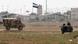 Turkish troops take their position at the Akcakale border gate in southern Sanliurfa province October 7, 2012, as a Syrian Independence flag waves at Syria's Tel Abyad border crossing in the background. Turkey returned fire after Syrian mortar bombs landed in a field in southern Turkey on Saturday, the day after Prime Minister Tayyip Erdogan warned Syria that Turkey would not shy away from war if provoked. It was the fourth day of Turkish retaliation for firing by Syrian forces that killed five Turkish civilians on Wednesday. REUTERS/Stringer (TURKEY - Tags: POLITICS MILITARY CONFLICT) Turkish troops take their position at the Akcakale border gate in southern Sanliurfa province October 7, 2012, as a Syrian Independence flag waves at Syria's Tel Abyad border crossing in the background. Turkey returned fire after Syrian mortar bombs landed in a field in southern Turkey on Saturday, the day after Prime Minister Tayyip Erdogan warned Syria that Turkey would not shy away from war if provoked. It was the fourth day of Turkish retaliation for firing by Syrian forces that killed five Turkish civilians on Wednesday. REUTERS/Stringer (TURKEY - Tags: POLITICS MILITARY CONFLICT)