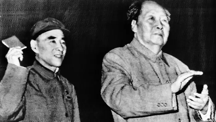 Communist China Chairman Mao Tse-Tung his chosen successor, Lin Piao, at People's Liberation Army reception in the Great Hall of the People in Peking Tuesday, October 1969. Lin waves a book of Mao quotations. (AP Photo)