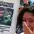 A woman reacts as she holds up a poster with an image of missing marine Luis Garcia during a protest organized by activists and relatives of people allegedly disappeared by rebels, in Bogota, Colombia, Sunday, Oct. 14, 2012. Demonstrators demanded participation in the peace talks between Colombia's government and Colombia's main leftist rebel movement, FARC, that will start on Monday in Norway. (Foto:Fernando Vergara/AP/dapd)