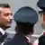 The captain of the Costa Concordia Francesco Schettino (L) is surrounded by Italian Carabinieri policemen as he leaves at the end of the preliminary hearings in Grosseto October 15, 2012. REUTERS/Max Rossi