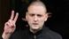 Opposition leader Sergei Udaltsov gestures while being escorted from his apartment after he was detained in Moscow, October 17, 2012. Opposition leader Sergei Udaltsov gestures while being escorted from his apartment after he was detained in Moscow, October 17, 2012.