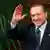Former Italian Prime Minister Silvio Berlusconi waves at the Chigi Palace in Rome in this November 16, 2011 file photo. Berlusconi said on October 9, 2012, he was ready to drop plans to lead the centre-right in next year's parliamentary election and did not rule out a second term for Prime Minister Mario Monti. REUTERS/Tony Gentile/Files (ITALY - Tags: POLITICS ELECTIONS)