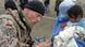 German soldier helps Afghan mother and child as part of ISAF contingent in Kabul, Afghanistan. Photo: AP Photo/ HO German soldier helps Afghan mother and child as part of ISAF contingent in Kabul, Afghanistan. Photo: AP Photo/ HO