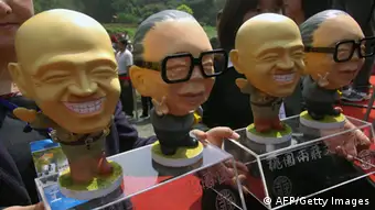 Local government tourism staff display the dolls of late presidents Chiang Kai-shek (L) and Chiang Chin-huo during a festival to promote the tourism, at the mausoleum of late president Chiang Kai-shek in Tashi, Taoyuan county, northern Taiwan, April 5, 2008. Taiwan's president-elect Ma Ying-jeou paid tribute to former nationalist Kuomintang (KMT) leader and president Chiang Kai-shek on the 33rd anniversary of his death. AFP PHOTO/Sam YEH (Photo credit should read SAM YEH/AFP/Getty Images)