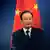 China's Premier Wen Jiabao stands in front of a Chinese national flag as he attends a joint news conference of the fifth trilateral summit among China, South Korea and Japan at the Great Hall of the People in Beijing, in this May 13, 2012 file photo. The family of Chinese Premier Wen Jiabao, a leader known for his humble roots and compassion for ordinary Chinese, has accumulated massive wealth during his time in power, the New York Times reported on October 26, 2012. REUTERS/Petar Kujundzic/Files (CHINA - Tags: POLITICS BUSINESS)