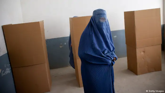 An Afghan woman votes at a polling station in parliamentary elections in 2010 (Photo: Majid Saeed)