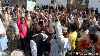 Pakistani demonstrators shout slogans near the Farooqi High School in Lahore (Photo: Arif Ali/AFP/Getty Images)