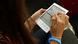 A young woman reading a book on an e-book reader. A young woman reading a book on an e-book reader.