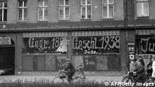 A picture dated 10 November 1938 in Germany showing a Jewish-run shop after being vandalized by Nazis and inscripted with antisemitic graffitis. Ordered by the Nazi party NSDAP in November 1938, rioters burnt down 267 synagogues, shattered the windows of some 7500 Jewish shops, desecrated Jewish cemeteries and beat people, 09 November 1938. Splintering glass panes and broken glass in the streets gave the pogrom the downplaying name 'Reichskristallnacht', or Crystal Night. AFP PHOTO / FRANCE PRESSE VOIR (Photo credit should read OFF/AFP/Getty Images)