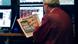 A trader on the floor of the New York Stock Exchange looks at the front page of a newspaper the day after Pres. Barack Obama was re-elected, Wednesday, Nov. 7, 2012 in New York. With President Barack Obama elected to another term, U.S. investors dumped stocks Wednesday and turned their focus to a world of problems, including a "fiscal cliff" of tax increases and spending cuts at home and a deepening recession in Europe. (Foto:Henny Ray Abrams/AP/dapd) A trader on the floor of the New York Stock Exchange looks at the front page of a newspaper the day after Pres. Barack Obama was re-elected, Wednesday, Nov. 7, 2012 in New York. With President Barack Obama elected to another term, U.S. investors dumped stocks Wednesday and turned their focus to a world of problems, including a "fiscal cliff" of tax increases and spending cuts at home and a deepening recession in Europe. (Foto:Henny Ray Abrams/AP/dapd)