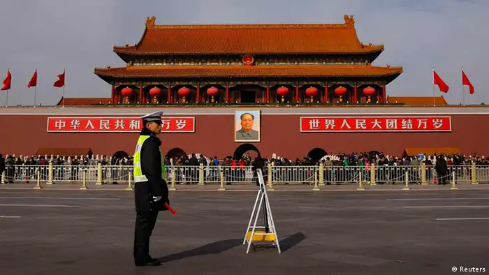 A policeman blocks the street in front of the giant portrait of former Chinese chairman Mao Zedong at Beijing's Tiananmen Gate November 7, 2012. Just days before the party's all-important congress opens, China's stability-obsessed rulers are taking no chances and have combed through a list all possible threats, avian or otherwise. Their list includes bus windows being screwed shut and handles for rear windows in taxis -- to stop subversive leaflets being scattered on the streets -- plus balloons and remote control model planes. The goal is to ensure an image of harmony as President Hu Jintao prepares to transfer power as party leader to anointed successor Vice President Xi Jinping at the congress, which starts on Thursday. REUTERS/Petar Kujundzic (CHINA - Tags: POLITICS)
