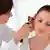 A doctor examines the ear of a woman 