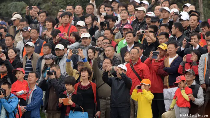 Members of the gallery pack in to watch world number one golfer Rory McIlroy of Northern Ireland and Tiger Woods of the US compete at the 'Duel at Jinsha Lake', a one-day golf challenge in Zhengzhou, in central China's Henan province on October 29, 2012. AFP PHOTO / GOH CHAI HIN (Photo credit should read GOH CHAI HIN/AFP/Getty Images)