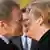 German Chancellor Angela Merkel (R) welcomes Poland's Prime Minister Donald Tusk before joint government talks at the Chancellery in Berlin November 14, 2012. REUTERS/Thomas Peter (GERMANY - Tags: POLITICS TPX IMAGES OF THE DAY)