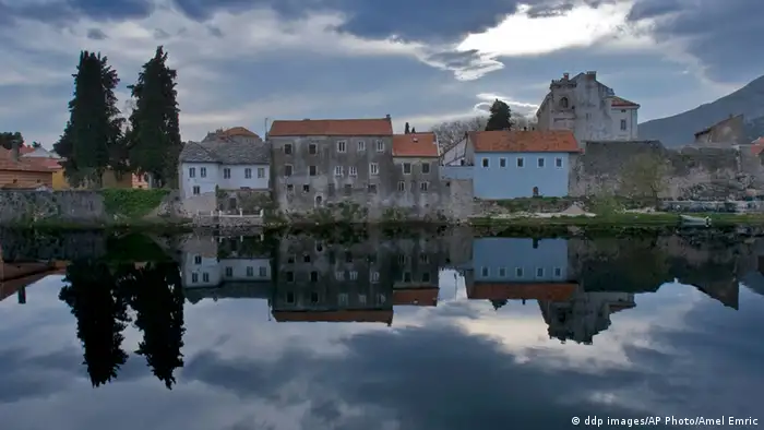 The buildings of the old town of Trebinje are reflected in the Trebisnjica River , 210 kms south of Sarajevo, in the early morning of Saturday, April 12, 2008. Tourist officials of the southernmost Bosnia-Herzegovina's town of Trebinje hope the tradition, cultural and historical heritage as well as the beautiful nature of the area will attract more domestic and foreign tourists to visit the town and its surrounding.