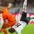 Nigel de Jong of the Netherlands fights for the ball with Mario Goetze of Germany (R) during their international friendly soccer match in Amsterdam November 14, 2012. REUTERS/Toussaint Kluiters/United Photos (NETHERLANDS-Tags: - Tags: SPORT SOCCER)