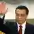 China's new Politburo Standing Committee member Li Keqiang waves to the press at the Great Hall of the People in Beijing, November 15, 2012. China's ruling Communist Party unveiled its new leadership line-up on Thursday to steer the world's second-largest economy for the next five years, with Vice President Xi Jinping taking over from outgoing President Hu Jintao as party chief. REUTERS/Carlos Barria (CHINA - Tags: POLITICS)