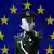 A Chinese paramilitary police officer reacts to having his photograph taken in front of the image of the European Union (EU) flag at the EU embassy in Beijing, (Photo: dpa)