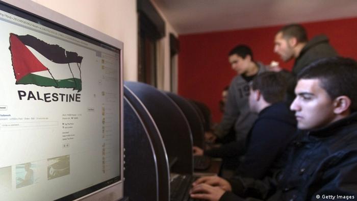 Palestinian youths check their facebook accounts at an internet cafe in the West Bank city of Ramallah on January 6, 2012 (Photo: AHMAD GHARABLI)
