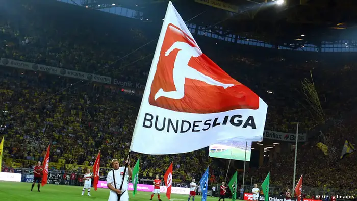 DORTMUND, GERMANY - AUGUST 24: A volunteer waves a flag othe the DFL during the Bundesliga match between Borussia Dortmund and Werder Bremen at Signal Iduna Park on August 24, 2012 in Dortmund, Germany. (Photo by Christof Koepsel/Bongarts/Getty Images)