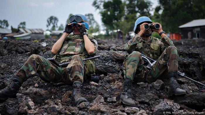 Uruguayan United Nations peacekeepers look through binoculars at M23 rebel positions on the outskirts of Goma, in eastern Democratic Republic of the Congo, on November 18, 2012. Government soldiers were fleeing the eastern DR Congo city of Goma in large numbers today as rebels advanced to the gates of the regional capital after fresh fighting erupted in the area last week, a UN source said. AFP PHOTO / PHIL MOORE (Photo credit should read PHIL MOORE/AFP/Getty Images)