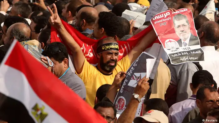 Supporters of Egyptian President Mohamed Mursi chant pro-Mursi slogans as they praise a new decree he issued on Thursday, during a protest in front of the presidential palace in Cairo November 23 , 2012. Mursi triggered controversy on Thursday by issuing a decree likely to lead to retrials of Hosni Mubarak and his aides but which was compared to the ousted leader's autocratic ways. REUTERS/Asmaa Waguih (EGYPT - Tags: POLITICS CIVIL UNREST)