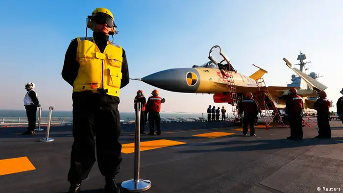 Staff members check a carrier-borne J-15 fighter jet on China's first aircraft carrier, the Liaoning, in this undated handout photo released by Xinhua News Agency on November 25, 2012. China has successfully conducted flight landing on its first aircraft carrier, the Liaoning, after its delivery to the People's Liberation Army (PLA) Navy on September 25, 2012, Xinhua News Agency reported. REUTERS/Xinhua/Zha Chunming (CHINA - Tags: MILITARY SCIENCE TECHNOLOGY POLITICS TRANSPORT) FOR EDITORIAL USE ONLY. NOT FOR SALE FOR MARKETING OR ADVERTISING CAMPAIGNS. THIS IMAGE HAS BEEN SUPPLIED BY A THIRD PARTY. IT IS DISTRIBUTED, EXACTLY AS RECEIVED BY REUTERS, AS A SERVICE TO CLIENTS. CHINA OUT. NO COMMERCIAL OR EDITORIAL SALES IN CHINA. YES